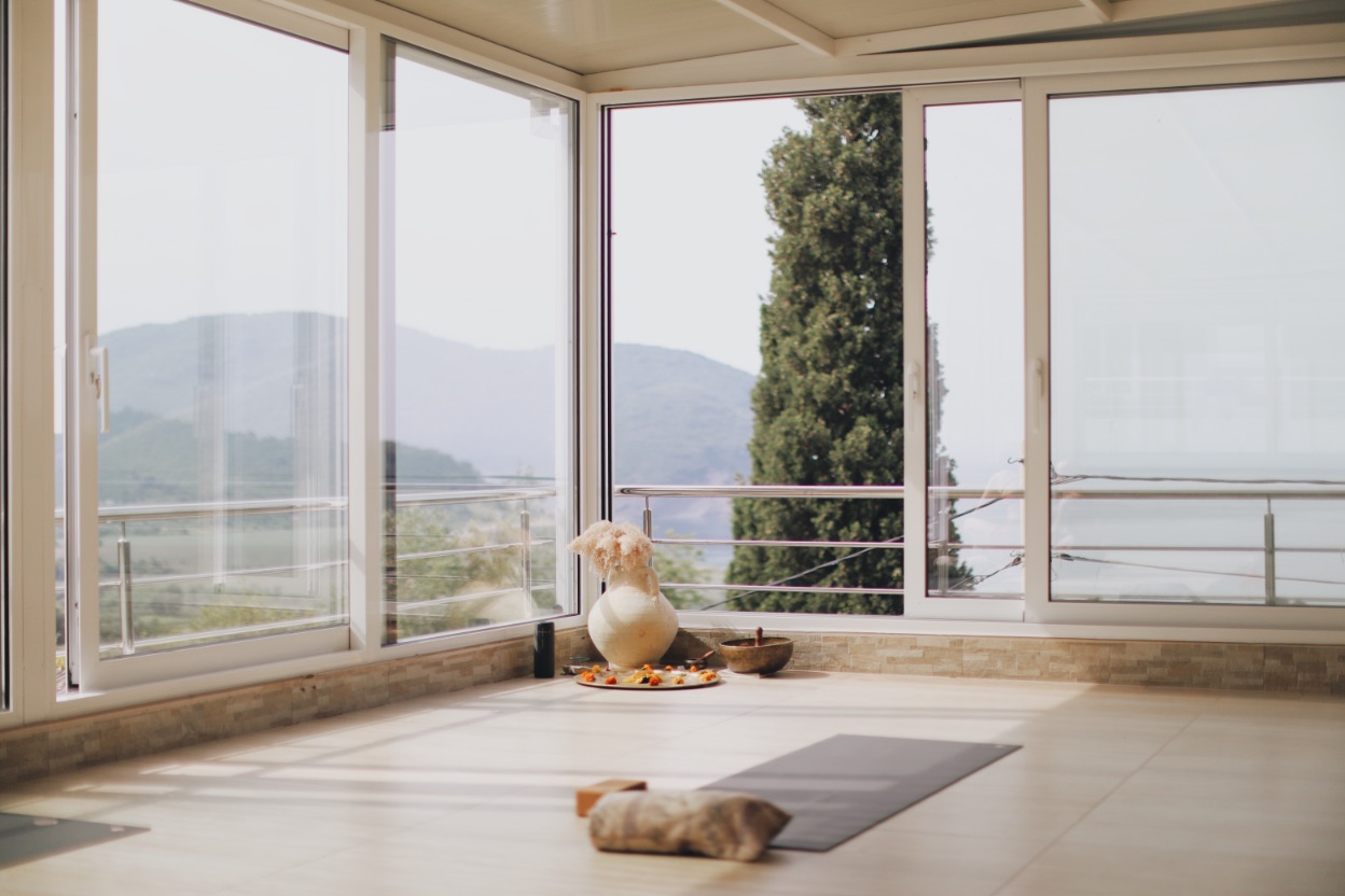 The glass-walled yoga shala at Mahakala Center, open to the sea and mountains